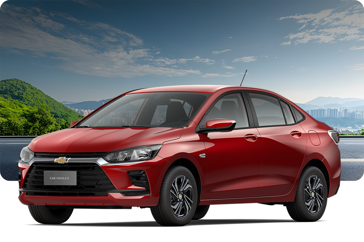 Chevrolet Onix AT Turbo na cor Vermelho Scarlet, em ambiente externo com gramado e céu aberto.