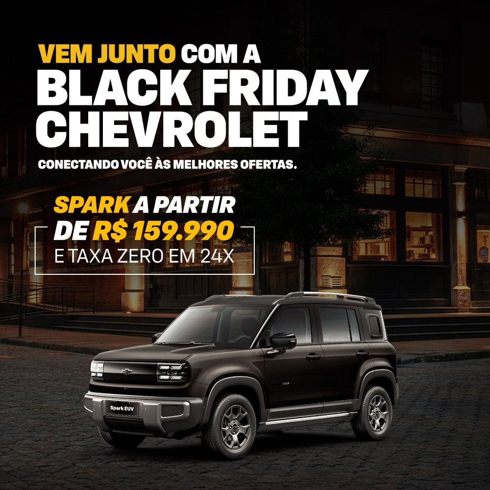 Uma Spark estacionada em uma rua da cidade à noite. A imagem promove a campanha de Black Friday da Chevrolet.