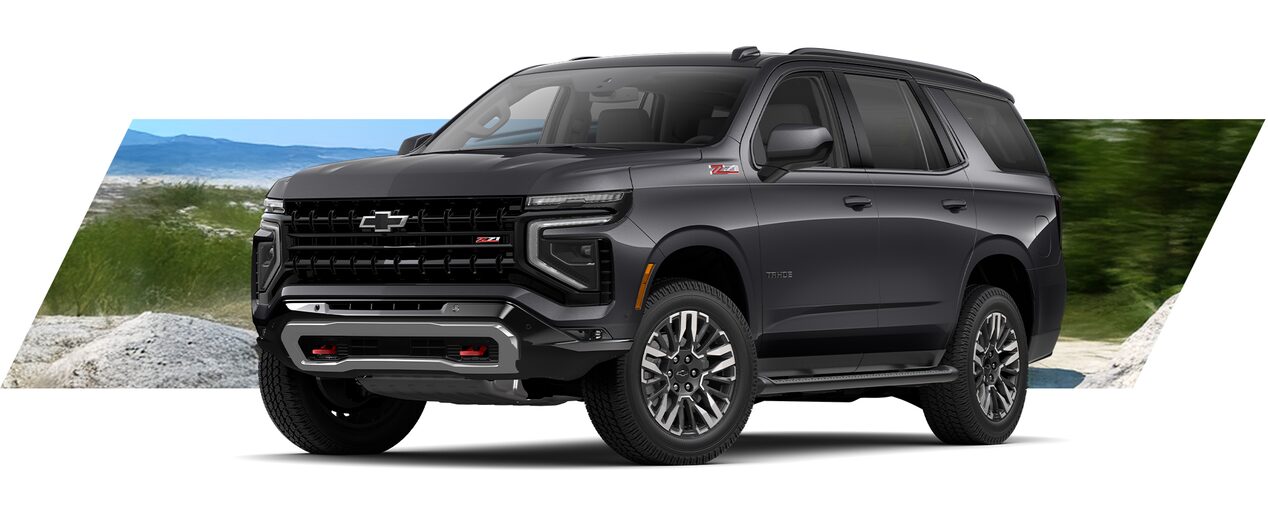 Chevrolet Suv Tahoe gris con diseño robusto y moderno, ideal para familias y viajes largos, en entorno natural de montaña